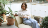 Office worker sitting on a archair reading  on a tablet